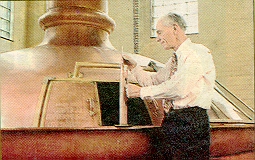 A brewer checking wort at an unknown brewery